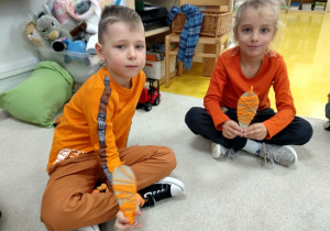 Chłopcy prezentują swoje marchewki.