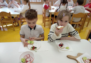 Przedszkolaki zjadają kanapki.