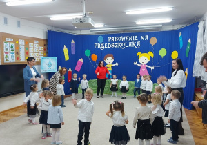 12. Dzieci w kole śpiewają piosenkę o deszczyku.