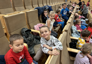 16 Uśmiechnięte przedszkolaki czekają na seans w kinie.