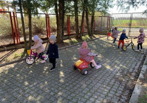 Dzieci z grupy Kropelek na rowerkach biegowych.