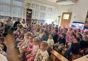 01 Dzieci siedzą na ławeczkach podczas spektaklu