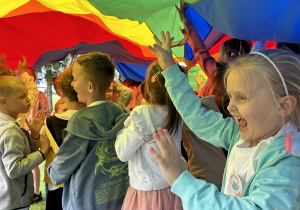 23 Uśmiechnięte dzieci bawią się pod chustą animacyjną