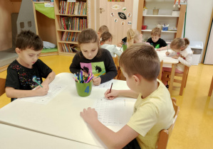 Dzieci piszą cyfrę 1.