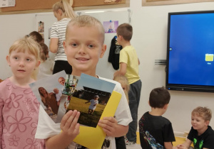 Chłopiec prezentuje zdjęcie z 1 urodzin.
