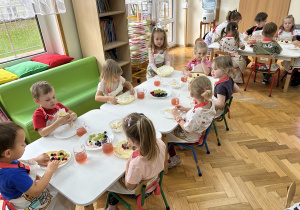 Przedszkolaki dekorują naleśniki wybranymi przez siebie owocami i sosami.