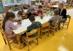 Dzieci zaczynają pracować przy stoliczku.