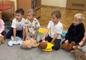 Chłopcy uczą się pierwszej pomocy na misiach.