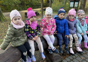 Czterolatki siedzą na ławce.