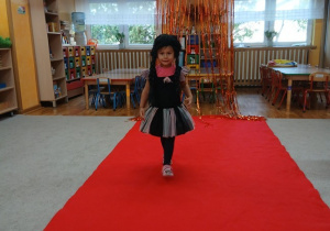 02. Dziewczynka w przebraniu idzie po czerwonym dywanie