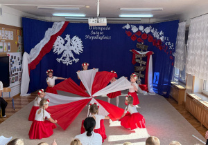 Dziewczynki utworzyły w tańcu wiatrak biało - czerwony.