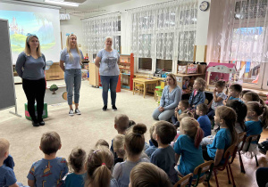 Dzieci siedzą i słuchają wiadomości o prawach dziecka.