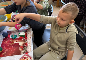 Chłopcy ozdabiają bombki.