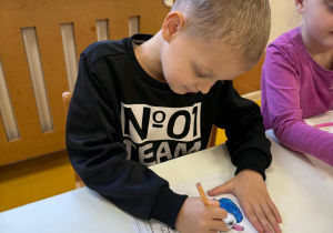 Chłopiec koloruje Bojka.