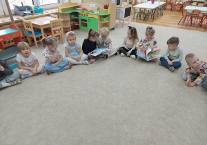 Czterolatki oglądają książki dla dzieci.