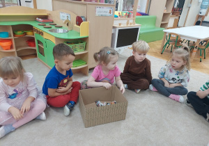 Dziewczynka przekazuje dalej pudełko.