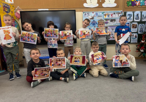 Dzieci pokazują ilustracje do opowiadania.