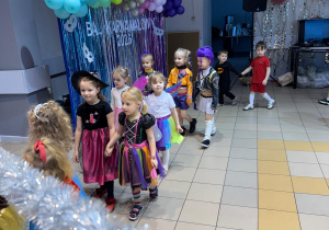 Dzieci parami przechodzą pod tyczką.