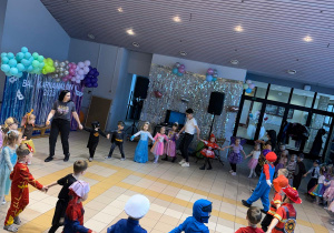 Dzieci tańczą w kole.