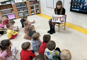 Pani Paulina czyta książkę o tematyce zimowej.