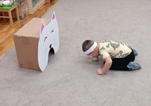 09 Chłopiec celuje piłeczkę do pudełka