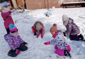 Dzieci lepią śnieżki.