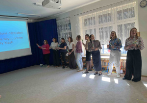 Panie śpiewają piosenkę przed całą społecznością przedszkolną.