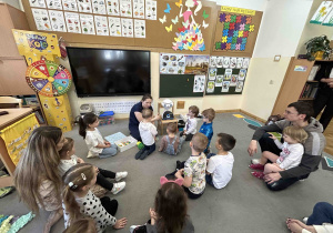 Dzieci z ciekawością biorą udział w zajęciach z robotem.