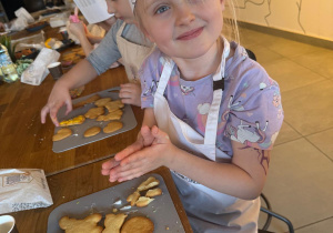 Dziewczynka prezentuje swoje ciasteczka.