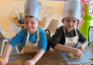 Chłopcy wałkują ciasto.