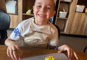 Szczęśliwy chłopczyk z babeczką.