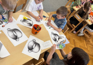 Dzieci przy stoliku i robią kucharza z pogodą.