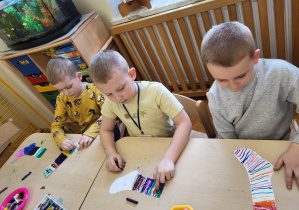 Chłopcy kolorują skarpetkę.