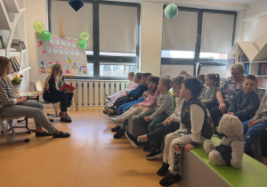 Dzieci z uwagą słuchają czytanej bajki.