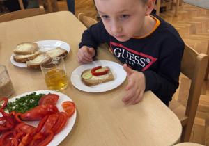 Chłopiec z przygotowaną przez siebie kanapką.