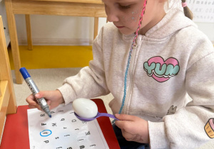 Dziewczynka wyszukuje literkę j.