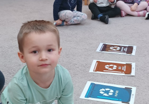 2. Chłopiec segreguje śmieci.