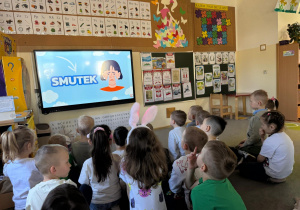 Dzieci wspólnie oglądają bajkę edukacyjną o emocjach.