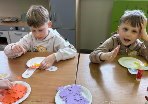 Chłopcy wykonują pracę plastyczną.