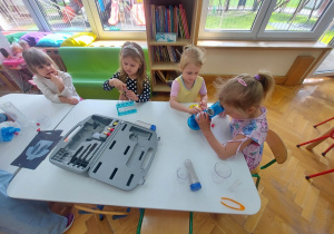 Dziewczynki bawią się w chemików laboratoryjnych.
