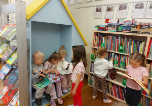 Dzieci oglądają książki w bibliotece
