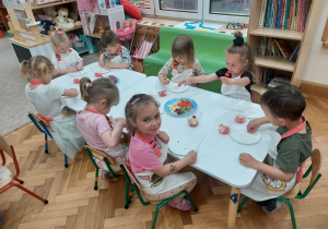 Dzieci kroją owoce, które będą dodatkiem do galaretki.