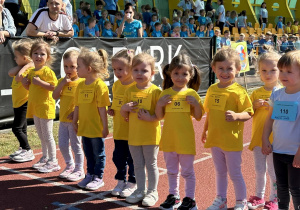 Dziewczynki z grupy Słoneczka stoją na starcie przed biegiem